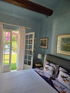 a bedroom with a bed and a door to a yard at Villa Provençal StTropez Ramatuelle Pampelonne beach in Saint-Tropez +36 photos