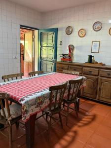 a kitchen with a table and chairs and a table and a counter at Sítio São Roque in São Roque