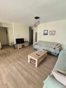 a living room with a couch and a table at Pine Lodge in Kavála