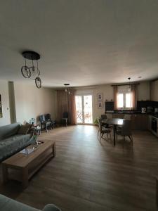 a living room with a couch and a table at Pine Lodge in Kavála