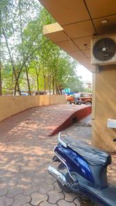 a blue scooter parked on the side of a building at Hotel Surya Palace - Durg Railway Station in Durg
