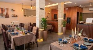 a restaurant with tables and chairs in a room at Hotel Surya Palace - Durg Railway Station in Durg