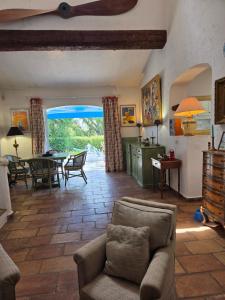 a living room with a couch and a table at Villa Provençal StTropez Ramatuelle Pampelonne beach in Saint-Tropez