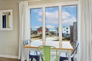 a dining room with a table and a large window at C308B - Duck Tails in Duck