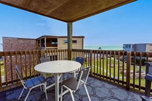 a patio with a table and chairs on a deck at C308B - Duck Tails in Duck