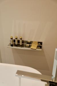 a shelf above a toilet in a bathroom at Andorini Hotel in Finiq +26 photos