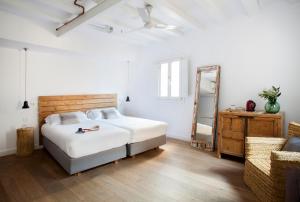 a bedroom with a bed and a dresser and a mirror at Eco Boutique Hostal Grau in Barcelona