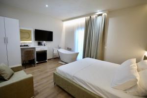 a hotel room with a bed and a desk at Andorini Hotel in Finiq