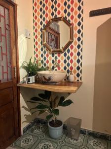 a bathroom with a sink and a mirror and a plant at The Mê Linh House in Nha Trang +23 photos