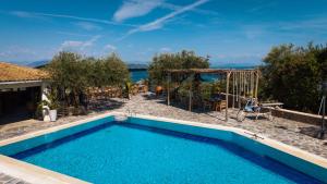 a swimming pool with a view of the ocean at Panorama Hideaway in Dassia