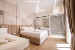 a hotel room with two beds and a mirror at Live in Gaeta in Gaeta +57 photos