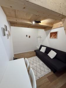 a living room with a black couch and a table at Milada 7 Suits in Brno