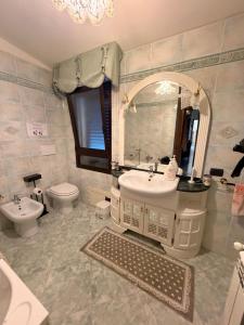 a bathroom with a sink and a toilet and a mirror at B&B Is Pranus a Mari Casa Privata in Solanas