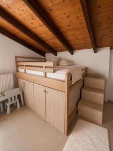 a bedroom with a bunk bed with a wooden ceiling at SkyVista Villa in Iraklitsa