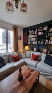 a living room with a couch and a coffee table at La Bonne Etoile, près Giverny in Vernon
