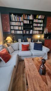 a living room with two white couches and a table at La Bonne Etoile, près Giverny in Vernon +6 photos