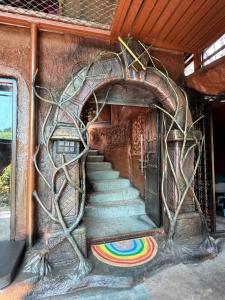 a painting of a stairway in a building at Rai’s Coorg Cave House in Madikeri