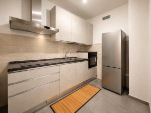 a kitchen with a sink and a refrigerator at Casa Mamma Etna in Riposto