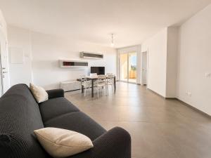 a living room with a couch and a dining room at Casa Mamma Etna in Riposto