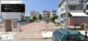 a car parked on a street next to some buildings at Relaxing home 80m from the sea in Perea