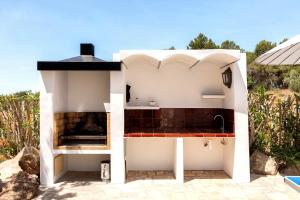 a kitchen in a house with a fireplace at New! Villa Can Mila in Sant Joan de Labritja +24 photos