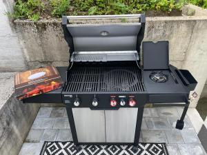 a barbecue grill sitting on top of a patio at WOOD hOUSE in Vrbovsko