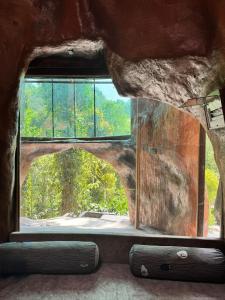 a view of a window in a room at Rai’s Coorg Cave House in Madikeri