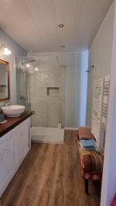 a bathroom with a sink and a shower and a tub at La Bonne Etoile, près Giverny in Vernon