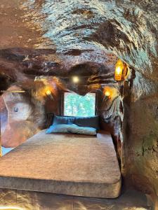 a bedroom in a cave with a bed in it at Rai’s Coorg Cave House in Madikeri