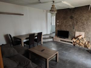 ein Wohnzimmer mit einer Couch, einem Tisch und einem Kamin in der Unterkunft imperial 2 in Leuenberg