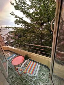 a balcony with a table and a chair on a balcony at The Mê Linh House in Nha Trang