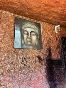 a statue of a head on the wall of a building at Rai’s Coorg Cave House in Madikeri +30 photos