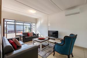 a living room with a couch and a tv at Safi Luxury Apartment 6 - 2 bedroom in East London