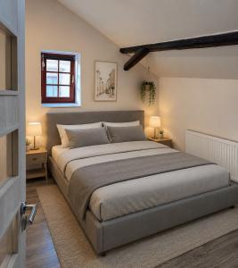 a bedroom with a large bed and two lamps at Apartment in Žatec in Žatec