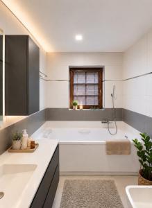 a white bathroom with a tub and a sink at Apartment in Žatec in Žatec +33 photos