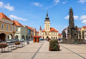 a city street with a clock tower and buildings at Apartment in Žatec in Žatec