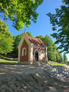 a small chapel with steps in front of it at Chatka przy kapliczce in Bugaj +7 photos
