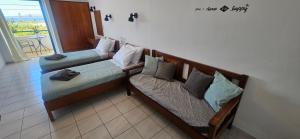 two wooden benches in a room with a balcony at Sky Eye Studios in Kokkini Khanion