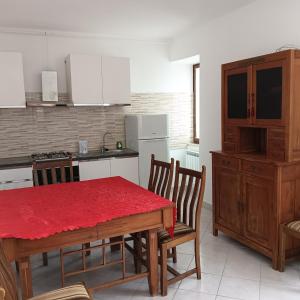 a kitchen with a table with a red table cloth on it at Villa Beregra in Lempa