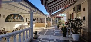 a porch of a house with potted plants at SANTA VENERE Apartments "PARCHEGGIO interno MOTO-AUTO" in Tropea