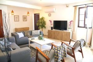 a living room with a couch and a tv at Casa C Alcoutim in Alcoutim