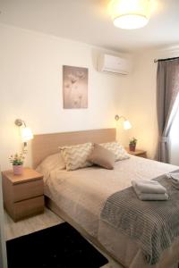 a bedroom with a bed with two lamps on it at Casa C Alcoutim in Alcoutim