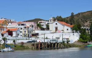 a view of a town with a river and buildings at Casa C Alcoutim in Alcoutim