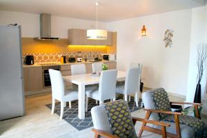 a kitchen and dining room with a table and chairs at Casa C Alcoutim in Alcoutim +45 photos