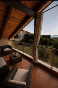 a room with a balcony with a large window at SkyVista Villa in Iraklitsa +8 photos