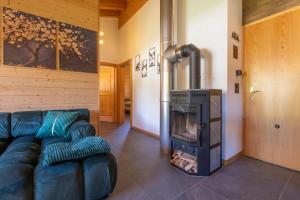 a living room with a couch and a fireplace at Ferienwohnung Aegimatte in Ulrichen