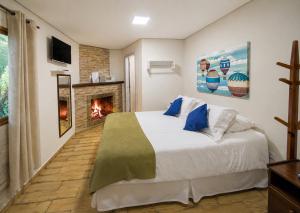 En eller flere senge i et værelse på Villa Vintage Campos - Piscina e opções de suites com hidromassagem