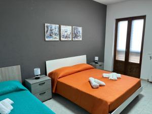 a bedroom with two beds with towels on them at Casa Vacanze del Salento in Sava