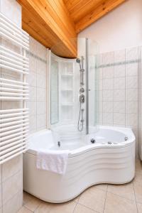 a white bath tub in a bathroom with a window at Residenz Château Leukerbad in Leukerbad