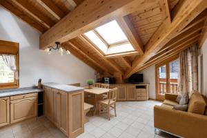 a kitchen and living room with a skylight at Residenz Château Leukerbad in Leukerbad